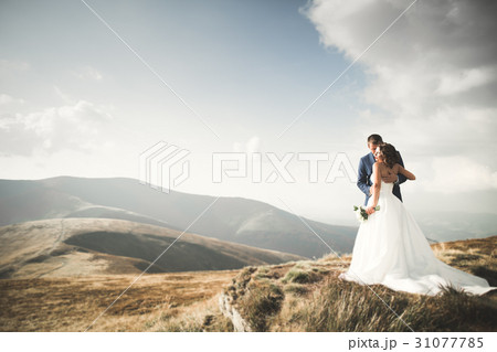 Wedding couple posing on sunset at wedding day 31077785