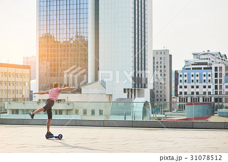 Guy on hoverboard, city. 31078512