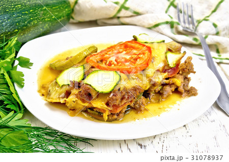 Casserole from minced meat and zucchini in plate 31078937