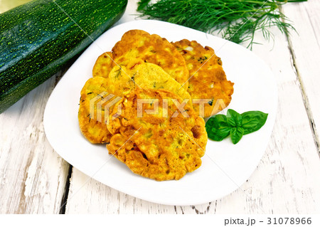 Flapjack chickpeas with zucchini in plate on board 31078966