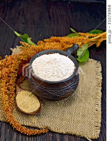 Flour amaranth in clay cup with flower on board 31078968