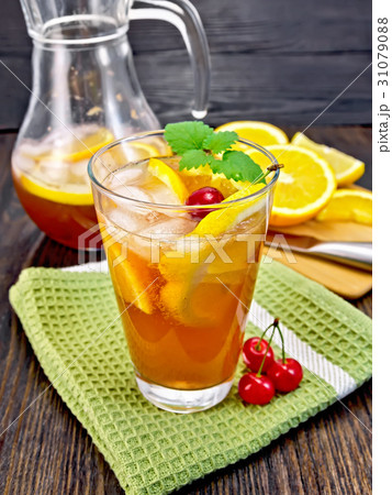 Lemonade with cherries in glassful and jug 31079088