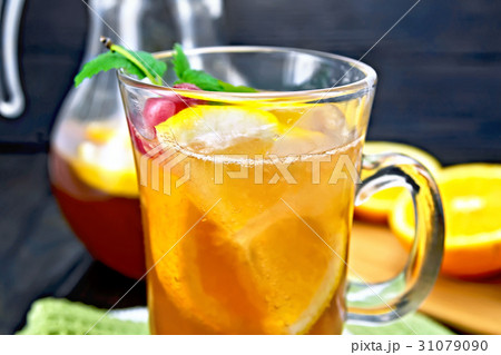 Lemonade with cherries in wineglass on table 31079090