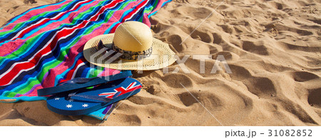 towel and sunbathing accessories on sandy beach 31082852