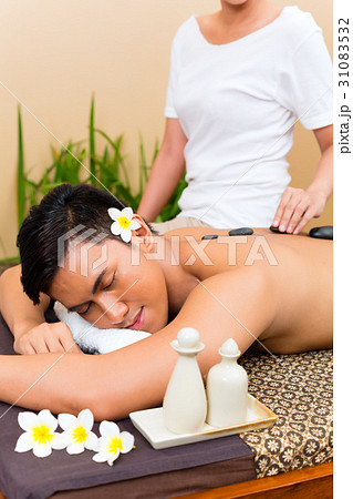 Indonesian man at hot stone wellness massage Indonesian man at hot stone wellness massage 31083532