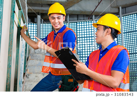 worker controlling building on construction site worker controlling building on construction site 31083543