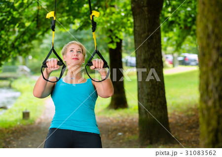 woman doing suspension sling trainer sport 31083562