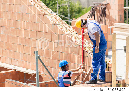 Two worker controlling construction  31083802