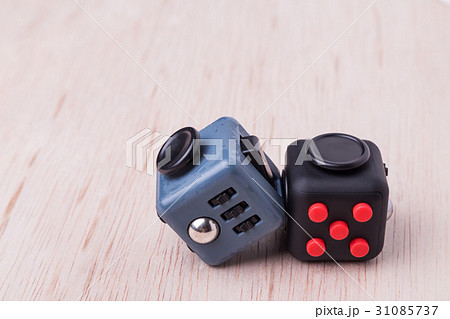 Fidget cube, the stress relieving cube on table Fidget cube, the stress relieving cube on table 31085737