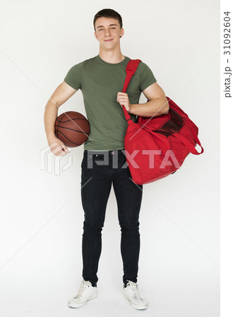 Mucsular sportsman holding basketball smiling casual studio portrait 31092604