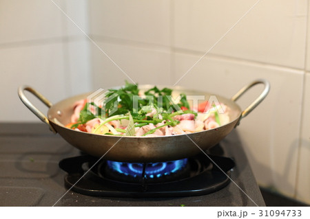 Happy housewife cooking squid with seafood in home 31094733
