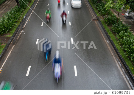 Undefined motorcycle traffic in rain Undefined motorcycle traffic in rain 31099735