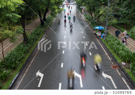 Undefined motorcycle traffic in rain 31099769
