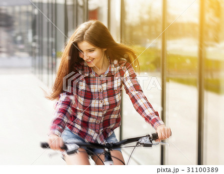 Young beautiful woman on a bicycle Young beautiful woman on a bicycle 31100389