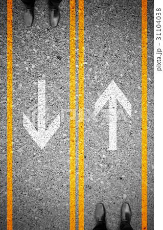 Two men standing on different side of the road 31104038