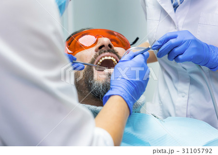 Two dentists and patient. Two dentists and patient. 31105792
