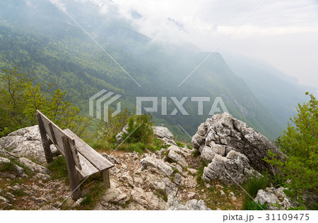 wooden bench with a view of the summer mountain 31109475