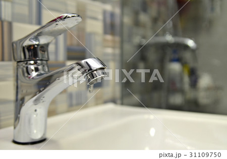 Bathroom tap leaking water drops 31109750