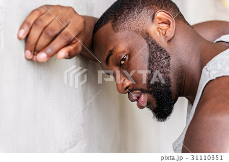 Tired young african sportsman having recreation Tired young african sportsman having recreation 31110351