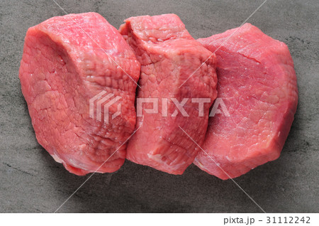 three piecea of raw beef meat on shale board three piecea of raw beef meat on shale board 31112242