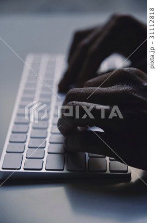 young man typing in a computer keyboard 31112818
