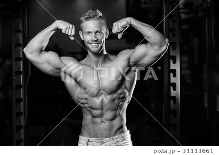 Handsome power athletic man on diet training pumping up muscles Handsome power athletic man on diet training pumping up muscles 31113661