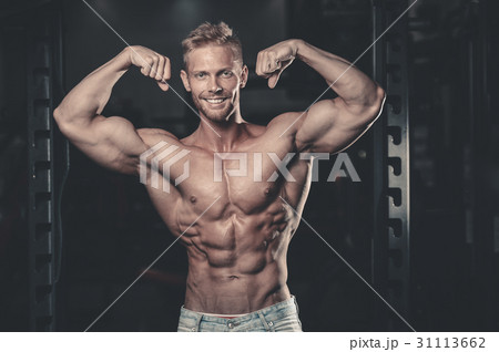 Handsome power athletic man on diet training pumping up muscles 31113662