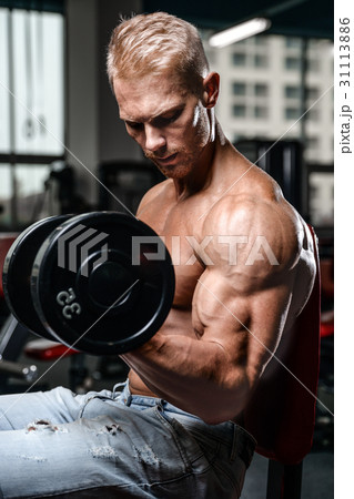 Handsome power athletic man on diet training pumping up muscles Handsome power athletic man on diet training pumping up muscles 31113886