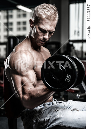 Handsome power athletic man on diet training pumping up muscles Handsome power athletic man on diet training pumping up muscles 31113887