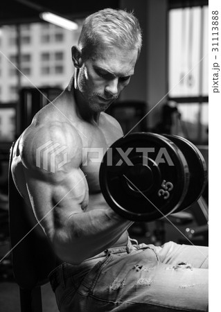 Handsome power athletic man on diet training pumping up muscles Handsome power athletic man on diet training pumping up muscles 31113888