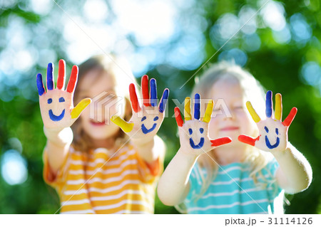 Adorable little sisters with their hands painted Adorable little sisters with their hands painted 31114126