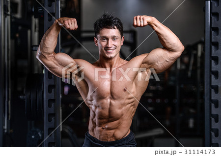 Handsome power athletic man on diet training pumping up muscles 31114173