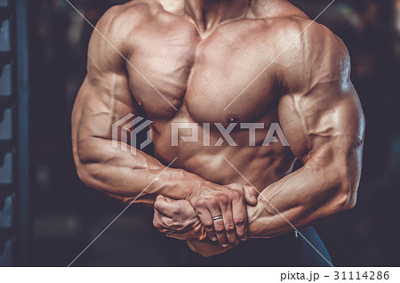 Handsome power athletic man on diet training pumping up muscles Handsome power athletic man on diet training pumping up muscles 31114286