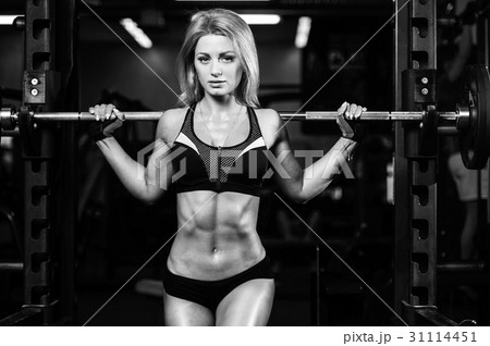 Girl execute exercise with barbell 31114451