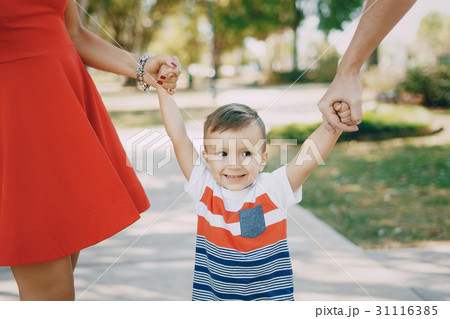 beautiful family in red walking down the street beautiful family in red walking down the street 31116385