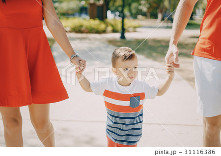 beautiful family in red walking down the street 31116386