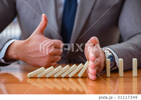 Businessman with dominoes in the office Businessman with dominoes in the office 31117349