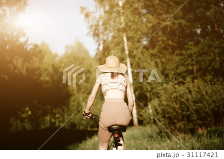 Funny girl driving bicycle outdoor. Sunny summer Funny girl driving bicycle outdoor. Sunny summer 31117421