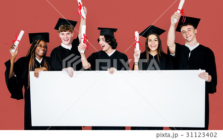 Diverse Students wearing Cap and Gown Showing Blank Copy Space Studio Portrait 31123402