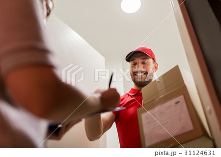 deliveryman and customer with parcel boxes at home deliveryman and customer with parcel boxes at home 31124631