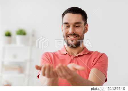 happy man holding something imaginary at home 31124648