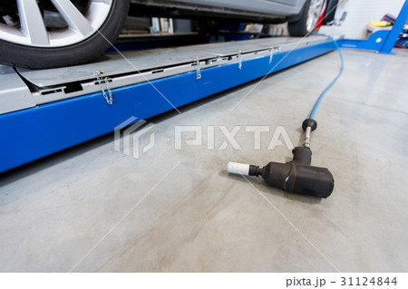 screwdriver and car at tire shop screwdriver and car at tire shop 31124844