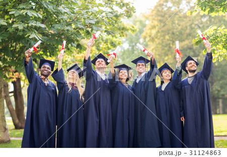 happy students in mortar boards with diplomas 31124863
