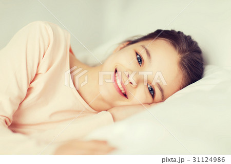happy smiling girl lying awake in bed at home happy smiling girl lying awake in bed at home 31124986