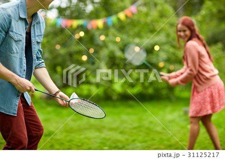 happy couple playing badminton at summer garden 31125217