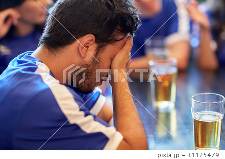 close up of sad football fan at bar or pub close up of sad football fan at bar or pub 31125479