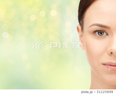 beautiful young woman half face over green beautiful young woman half face over green 31125699