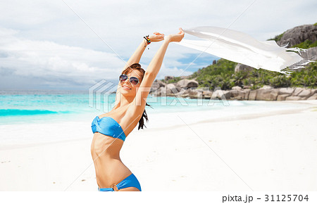 woman in bikini and sunglasses with pareo on beach woman in bikini and sunglasses with pareo on beach 31125704