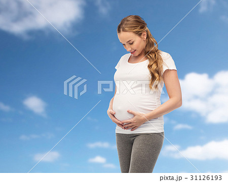 happy pregnant woman touching her big belly happy pregnant woman touching her big belly 31126193