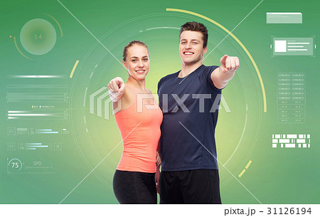 happy sportive man and woman pointing finger happy sportive man and woman pointing finger 31126194